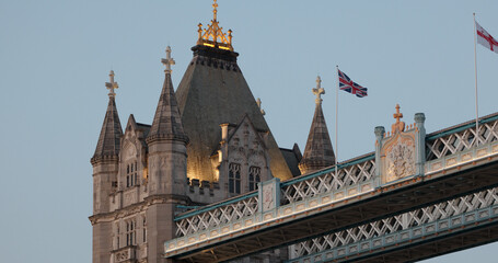 Tower Bridge in London with british flags waving at sunset