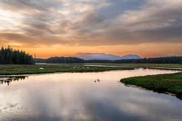 Sunset in Arcadia, Maine USA over a river and mountain landscape.