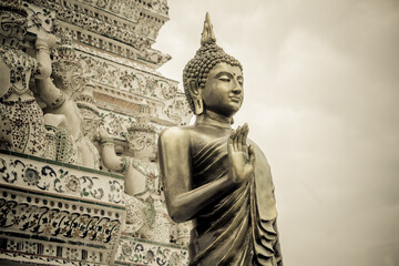 Gold statue at Wat Arun is one of a famous Buddhist temple in the Bangkok, Thailand