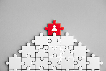 Red puzzle piece leadership concept for business success and individual achievement and team building strategy