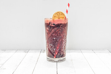 Freshness with a Berry Twist: A frosted glass of red berry lemonade, garnished with whole...