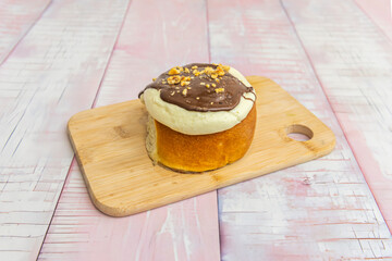 Delicious and fluffy cinnamon rolls topped with dulce de leche sauce and chopped walnut pieces