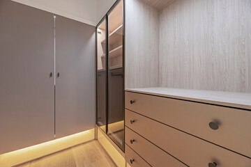 Smooth  wood bookcase with folding glass doors and drawers with minimalist metal handles