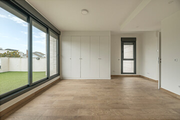 An organically designed living area with soft curves in the architecture and natural materials, ready to receive furnishings