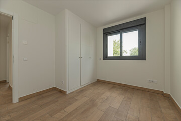 Empty   bedroom with neutral-themed white wardrobes and doors that can be personalized with...