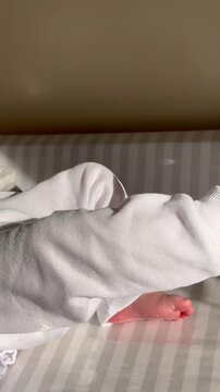 Newborn feet. Baby feet and legs moving.
