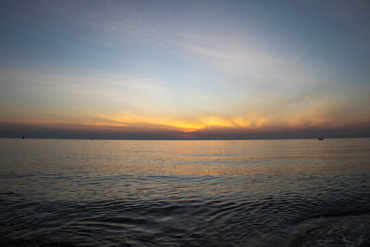 Beautiful sunset on the sea beach with coconut tree for travel in holiday
