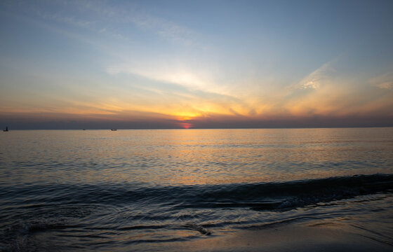 Beautiful sunset on the sea beach with coconut tree for travel in holiday