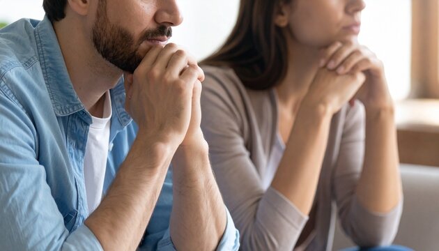 Crop close up of unhappy young couple sit separate have problems in relationship think of breakup or divorce. Upset man and woman family lovers avoid talking suffer from cheating in relation troubles.