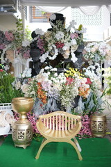Elegant Decorative Setup with Golden Chair and Floral Accents
