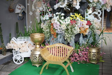 Elegant Decorative Setup with Golden Chair and Floral Accents
