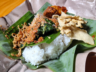Nasi pecel or sego pecel is a typical Javanese Indonesian rice dish served with pecel sauce, which...