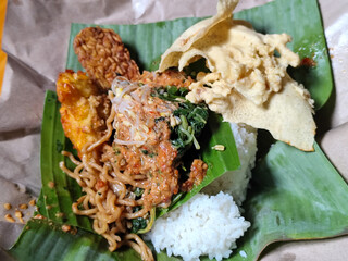 Nasi pecel or sego pecel is a typical Javanese Indonesian rice dish served with pecel sauce, which...