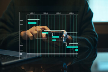 Hands typing on laptop with a digital Gantt chart overlay. Ideal for project planning, scheduling,...