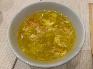 crab and corn soup on a white bowl