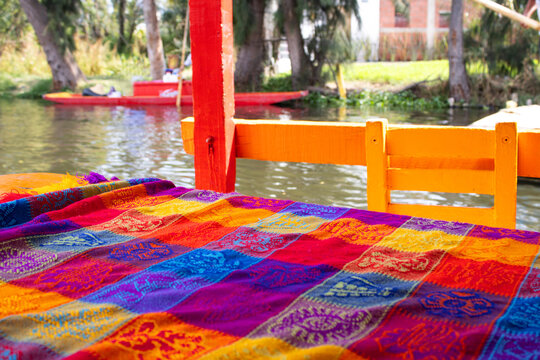 Traditional colorful tablecloth on a table of a trajinera in Xochimilco