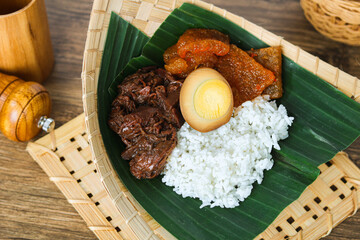 Authentic Nasi Gudeg, a traditional Javanese dish from Indonesia, featuring tender young jackfruit...