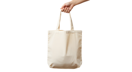 Hand holding a reusable beige cotton tote bag with fabric handles.