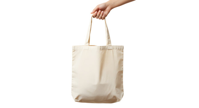 Hand holding a reusable beige cotton tote bag with fabric handles.