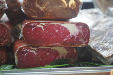 Freshly sliced meat displayed in a market