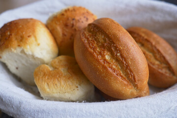 Freshly baked bread rolls in a cloth basket