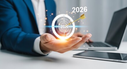 Businessman aiming for 2026 target with arrow hitting bullseye in his hand