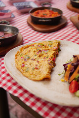Delicious omelette with fresh vegetables served outdoors