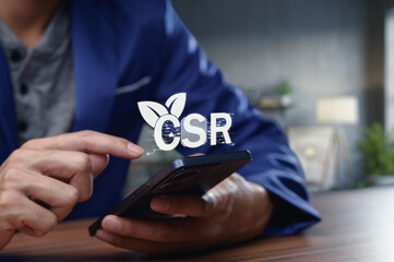 Person Engaging with CSR Concepts on Mobile Device in Office Setting