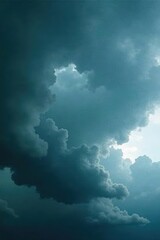 Heavy, dark grey clouds dominate the sky, threatening rain , weather, cloudscape