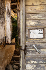 Sardara, Sardinia, Italy An old wooden house and a sign in Italian says Vendesi,  For Sale.