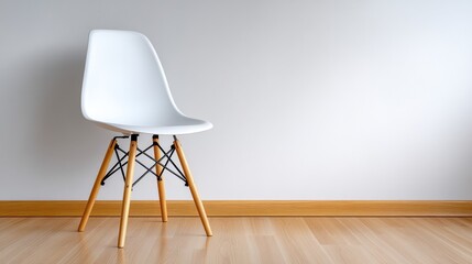 Minimalist white chair with wooden legs in bright, modern interior space.
