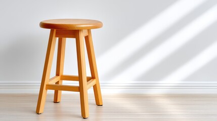 Minimalist wooden stool in a bright, sunlit interior.