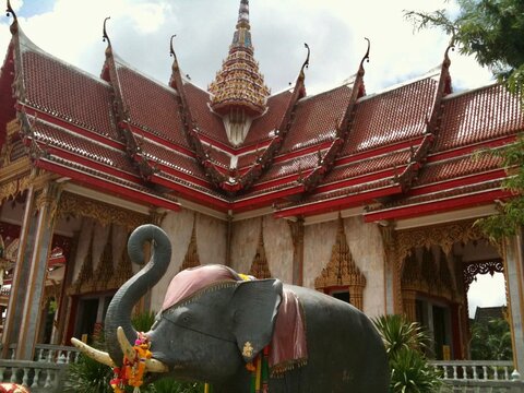 Thai temple,  Wat Chalong  in Puket Thailand Southeast Asia, with elephants, red golden roof and Elephant statue