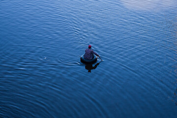 Person Kayaking on Calm Water Surface in Scenic Outdoor Photo
