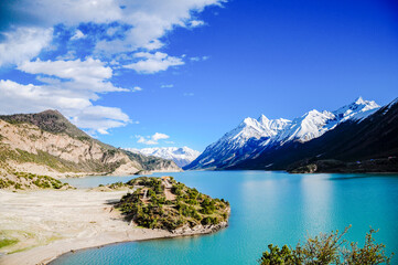 Glacial Snowcapped Mountains Framing Tranquil Ranwu Lake In Tibet