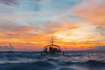 Long Exposure Seascape With Boats At Sunset On Coastline