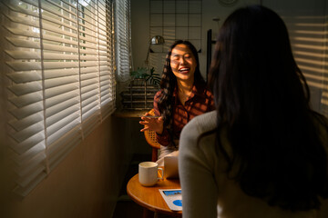 Two businesswomen discussing marketing strategy during a meeting in office