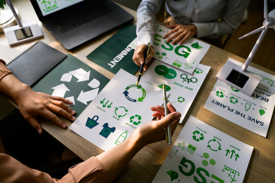 Managers discussing esg strategy for environment conservation with recycle symbol
