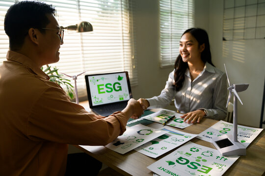 Managers shaking hands after closing a deal on environmental, social, and governance project - Powered by Adobe