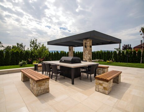 Modern outdoor kitchen and dining area with stone accents, pergola, and built-in grill