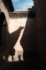 Shadows and rooftops of ancient Chinese temple architecture in natural light