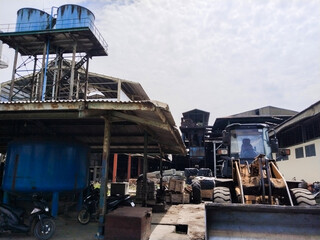 Heavy-duty wheel loader at industrial site, used for material handling and construction. Ideal for agriculture, mining, factory operations, logistics, and industrial stock photo needs