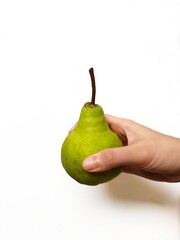 Fresh green pear held in hand on white background. Perfect for healthy lifestyle, nutrition,...
