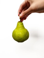 Fresh green pear held in hand on white background. Perfect for healthy lifestyle, nutrition,...
