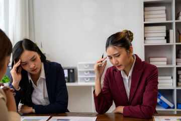 Businesswomen having headache and feeling tired from overworking in office