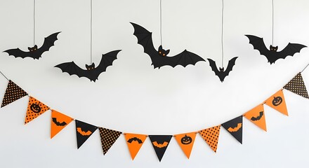 Festive halloween decorations hanging from the ceiling with bats and a banner of orange and black triangles