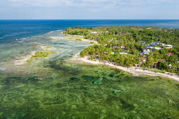 Scenic Aerial Drone Panorama picture of Cloud 9 surfing beach with waves in Siargao, Surigao den...