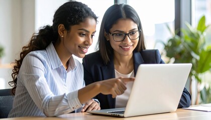 Close up confident Indian businesswoman mentor teaching African American intern. Using laptop, pointing at computer screen. Helping with corporate software. Detailed high quality image. 