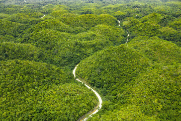 Scenic Aerial drone picture of the hilly mountains with road in Loboc, Bohol, near the Chocolate...