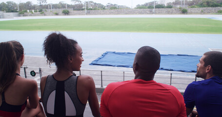 Talking, team and athlete on break, stadium or people on bleachers for competition or...
